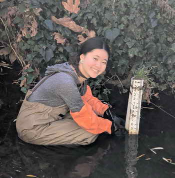 UC Berkeley senior Carly Lu reads water temperatures in Cerrito Creek